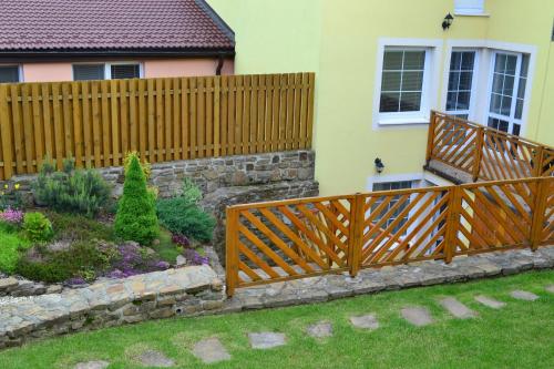 a wooden fence in front of a house at Privat Julia in Vrbov