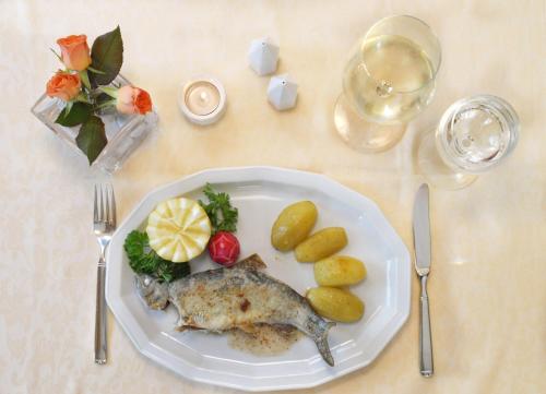 a plate of food with fish and vegetables on a table at Salzburger Stubn in Kleinarl