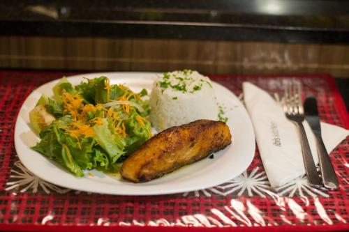 a plate of food with a vegetable and salad on a table at ibis Maceio Pajuçara in Maceió