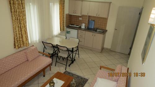 a living room with a couch and a table at Arya Otel in Marmaris