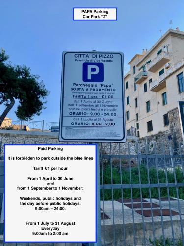 a sign on a fence in front of a building at Studio Sant'Antonio in Pizzo