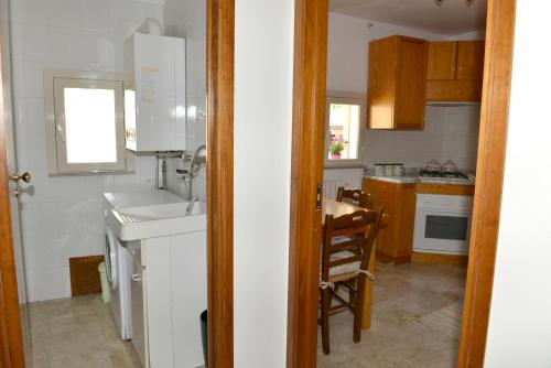 a kitchen with a sink and a table at Niria Home in Catania