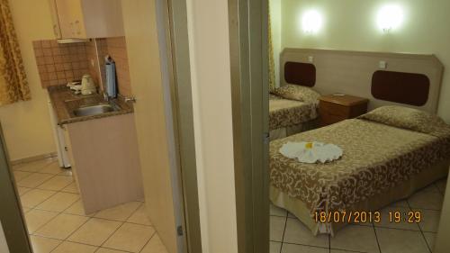 a small room with two beds and a sink at Arya Otel in Marmaris