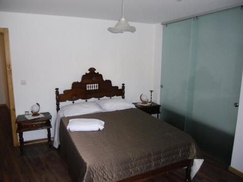 a bedroom with a bed with two towels on it at Casas de Campo Podence in Macedo de Cavaleiros