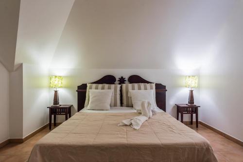 a bedroom with a large bed with two night stands at Village Pierre & Vacances Sainte Luce in Sainte-Luce