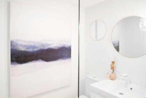 a bathroom with a mirror and a sink at City Valencia Beach 360 in Valencia