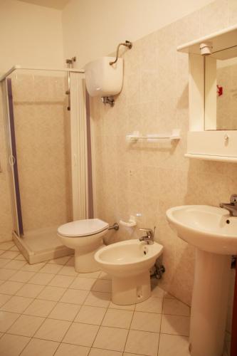 a bathroom with a toilet and a sink and a shower at Baia di Zambrone in Zambrone