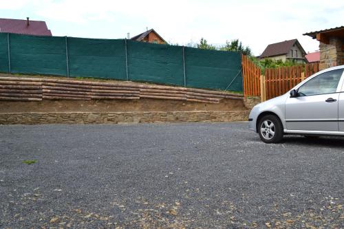 a silver car parked in front of a fence at Privat Julia in Vrbov