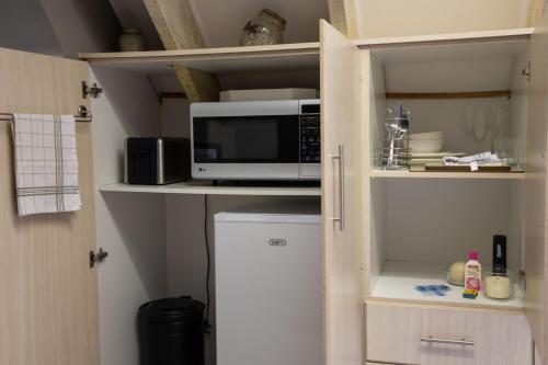 a kitchen with a microwave and a small refrigerator at The Bergzicht Guest Suite in Cape Town