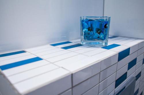 a glass vase sitting on top of a tiled counter at Kaszubskie Zacisze in Władysławowo