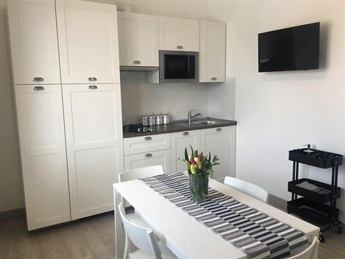 a kitchen with a table with a vase of flowers on it at Green House in campagna in Melara