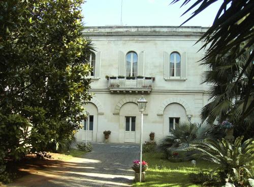 a large white building with a balcony on top of it at ANTICA VILLA La Viola, Suite with private pool in Lecce