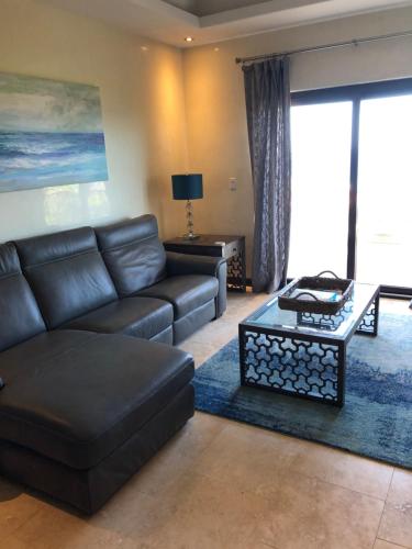 a living room with a couch and a coffee table at The Meridian at Lighthouse Point in West Bay