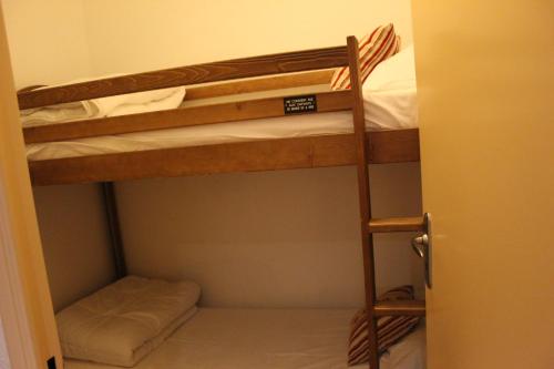 a small room with two bunk beds in it at Appartement Nolhan in Cauterets