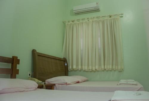 Postel nebo postele na pokoji v ubytování Hotel Barão Do Rio Branco