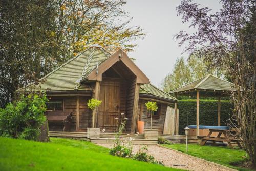a small wooden cabin with a gazebo at Burton Lodge Guest House & Spa in Brandesburton