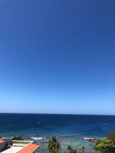 a view of the ocean from the balcony of a resort at The Meridian at Lighthouse Point in West Bay