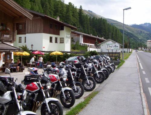 a row of motorcycles parked on the side of a street at Dorf Alm in Obergurgl