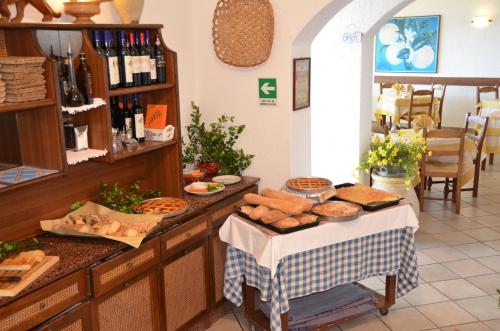 a bakery with a table with bread and other foods at Hotel La Gioiosa in Finale Ligure