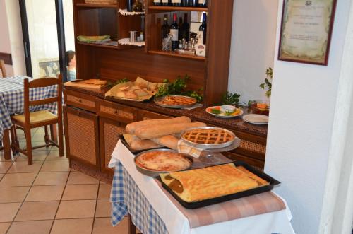 a table topped with lots of different types of food at Hotel La Gioiosa in Finale Ligure