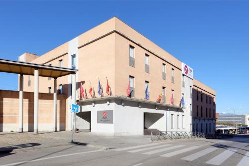 a building with flags on the front of it at Exe Tres Cantos in Tres Cantos