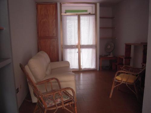 a living room with a couch and chairs and a window at Uliveto in Sulzano