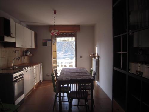a kitchen with a table and chairs and a window at Uliveto in Sulzano
