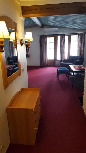 a living room with a couch and a table at Sälens Bed & Breakfast Apartments in Sälen