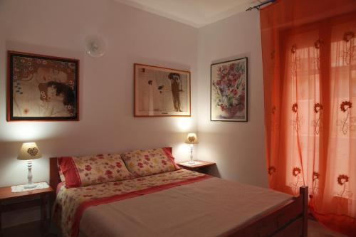 a bedroom with a bed and two lamps on tables at Casa Pireddu in Cala Gonone