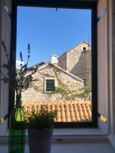 a window with a view of a building at Villa San Marco in Hvar