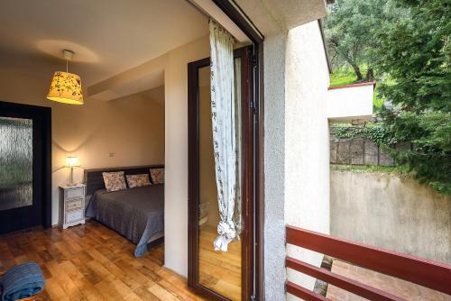 a bedroom with a bed and a sliding glass door at Villa Milana Budva in Budva