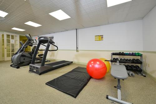 a gym with a treadmill and a ball and exercise equipment at Bar Harbor Grand Hotel in Bar Harbor