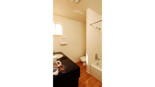 a bathroom with a toilet and a sink at Winners Inn Casino in Winnemucca