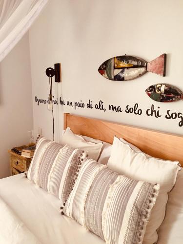a bedroom with a bed with a sign on the wall at Ewange - A Casa Mia in Kampala
