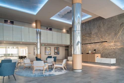 a lobby with chairs and a table in a building at Belise Apartments in Brisbane