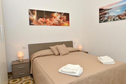 a bedroom with a bed with two towels on it at Sweet Home Positano in Positano