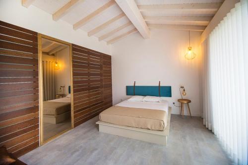 a bedroom with a bed and a large mirror at Casa Lugar da Aldeia in Barcelos