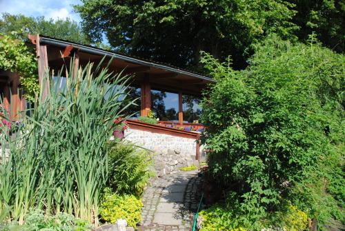 a garden with a stone path in front of a house at Hotel Ruhekrug in Schleswig