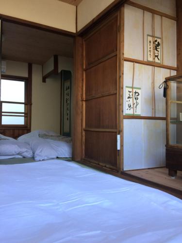 Postel nebo postele na pokoji v ubytování Suzume-An