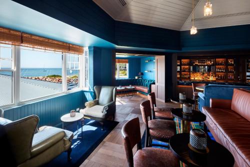 a room with a bar with a view of the ocean at Anchorage Port Stephens in Nelson Bay