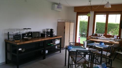 a kitchen with a counter and a table with chairs at Il Sole e la Luna B&B in Garda in Garda
