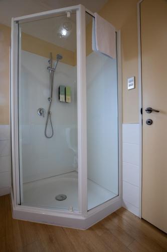 a shower with a glass door in a bathroom at Abbella Lodge Motel in Christchurch