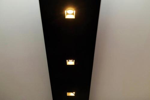 a room with two lights on the wall at Sapphire Apartment in Rome