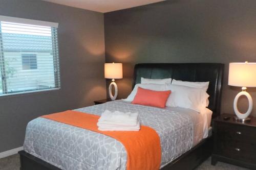 a bedroom with a large bed with two lamps at Adventure Home Rentals in Phoenix