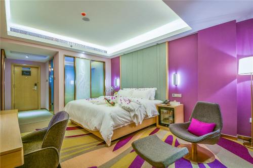 una camera da letto con un grande letto con pareti viola di Lavande Hotel Dali Erhai Park Branch a Dali