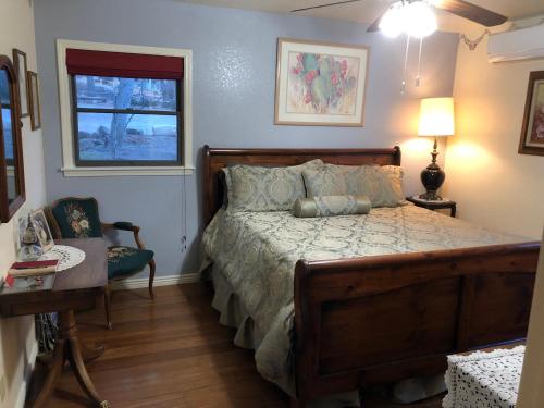 a bedroom with a bed and a table and a window at Ramsey Canyon B&B in Nicksville
