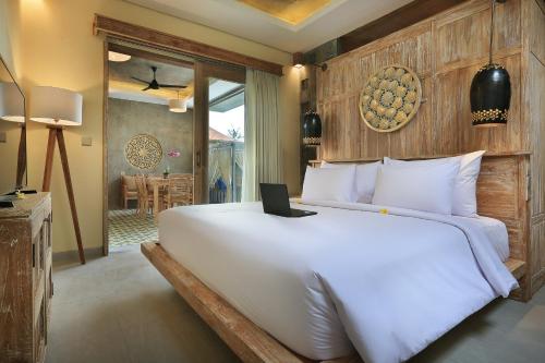 Postel nebo postele na pokoji v ubytování Amareka Ubud by GenuineHost