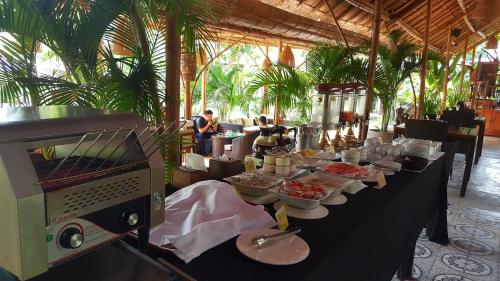 a buffet line with plates of food in a restaurant at Sahaa Beach Resort in Sihanoukville