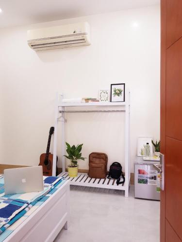 a white room with a bed and a laptop at Quyen's house in Can Tho