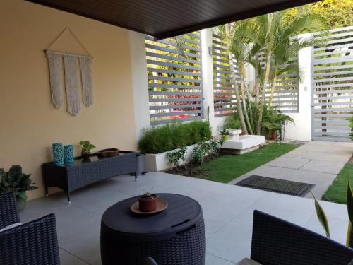 a patio with a table and chairs and a building at Runway 108 in Managua
